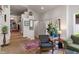 Comfortable living room with Terrazzo floors, an olive green sofa and view of the staircase at 5424 Broadway St, Indianapolis, IN 46220