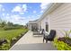 Relaxing back patio featuring outdoor seating, lounge chairs, and a well-manicured lawn at 5723 Arctic Run Dr, Noblesville, IN 46062