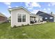 Spacious backyard featuring a patio with outdoor seating and tasteful landscaping around the yard's perimeter at 5723 Arctic Run Dr, Noblesville, IN 46062