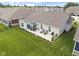 Aerial view of a backyard featuring a patio with outdoor seating and a well-manicured lawn at 5723 Arctic Run Dr, Noblesville, IN 46062