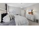 Neutral bedroom featuring a bed with accent pillows, lighting, and an adjacent room at 5723 Arctic Run Dr, Noblesville, IN 46062