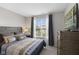 Cozy bedroom featuring a comfortable bed, soft lighting, and a large window for natural light at 5723 Arctic Run Dr, Noblesville, IN 46062