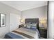 Comfortable bedroom boasts soft bedding, bedside tables with lamps, and soft, neutral colored walls at 5723 Arctic Run Dr, Noblesville, IN 46062