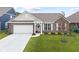 Charming brick home featuring a two-car garage and well-maintained landscaping at 5723 Arctic Run Dr, Noblesville, IN 46062