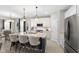 Modern kitchen with granite countertops, a stainless steel fridge and three bar stools at 5723 Arctic Run Dr, Noblesville, IN 46062