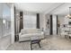 Well-lit living room with a sofa, ottoman, and view into the kitchen at 5723 Arctic Run Dr, Noblesville, IN 46062