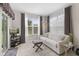 Bright living room featuring a sofa, accent chair, and sliding glass doors at 5723 Arctic Run Dr, Noblesville, IN 46062