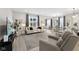 Bright living room featuring neutral tones, stylish furnishings, and ample natural light from the large window at 5723 Arctic Run Dr, Noblesville, IN 46062