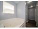 Bathroom featuring a large soaking tub, walk in shower, and hardwood-style flooring at 5859 Edelle Dr, Indianapolis, IN 46237