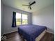 Comfortable bedroom with a ceiling fan and window with view for relaxation at 5859 Edelle Dr, Indianapolis, IN 46237
