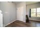 Bright foyer featuring a white door, hardwood flooring, and natural light from the window at 5859 Edelle Dr, Indianapolis, IN 46237