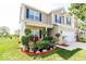 Charming two-story home featuring blue shutters, front porch and an eye-catching landscaped yard at 5859 Edelle Dr, Indianapolis, IN 46237