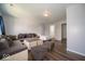Spacious living room featuring a sectional sofa, ottoman, and hardwood-style flooring at 5859 Edelle Dr, Indianapolis, IN 46237