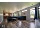Expansive living room featuring hardwood floors, a fireplace, and a seamless flow to the kitchen at 5859 Edelle Dr, Indianapolis, IN 46237
