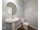 Simple powder room featuring a pedestal sink, toilet, and neutral paint, offering convenience and style at 5859 Edelle Dr, Indianapolis, IN 46237