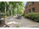 A brick home featuring a brick patio with table set and a lush green lawn at 5997 Hollythorn Pl, Carmel, IN 46033
