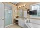 Bathroom with standalone shower, tile floor, white cabinets and a mounted television at 5997 Hollythorn Pl, Carmel, IN 46033