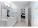 Bathroom with dual sinks, white cabinets and view of the sports themed bedroom next door at 5997 Hollythorn Pl, Carmel, IN 46033