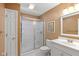 Bathroom featuring a glass shower, white vanity, and medicine cabinet with mirror at 5997 Hollythorn Pl, Carmel, IN 46033