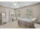 Bright bedroom featuring neutral walls, ceiling fan, and two windows allowing plenty of natural light at 5997 Hollythorn Pl, Carmel, IN 46033