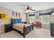 Bedroom featuring ceiling fan, windows and bed with sports decor at 5997 Hollythorn Pl, Carmel, IN 46033