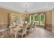 Bright dining room with a large window, a chandelier, and ample seating for dinner parties at 5997 Hollythorn Pl, Carmel, IN 46033