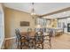 Charming eat-in kitchen flows into a dining area featuring a rustic chandelier and a view of the kitchen at 5997 Hollythorn Pl, Carmel, IN 46033