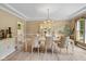 Formal dining room with wainscoting, a chandelier, and space for entertaining at 5997 Hollythorn Pl, Carmel, IN 46033