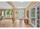 Elegant foyer featuring hardwood floors, decorative columns, and a view of the front yard through a large window at 5997 Hollythorn Pl, Carmel, IN 46033