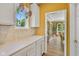 Spacious, updated kitchen features hardwood floors and white cabinets; it opens into a dining room at 5997 Hollythorn Pl, Carmel, IN 46033