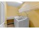 Bright laundry room with front load washer and dryer, built in counter and storage baskets at 5997 Hollythorn Pl, Carmel, IN 46033