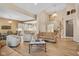Bright living room boasts a cathedral ceiling, hardwood floors, and stairs to a second-floor balcony at 5997 Hollythorn Pl, Carmel, IN 46033