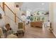 Bright living room featuring hardwood floors, a staircase, and a fireplace at 5997 Hollythorn Pl, Carmel, IN 46033