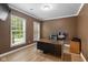 Office space featuring hardwood floors, a window, and a desk at 5997 Hollythorn Pl, Carmel, IN 46033