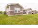 Exterior view of backyard with brick and siding details and a well-maintained lawn at 610 Sawtooth St, Westfield, IN 46074