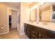 Bathroom with a double sink vanity, modern fixtures, and tile flooring, with a closet for additional storage at 610 Sawtooth St, Westfield, IN 46074