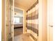 A peek inside this bathroom features a tiled floor and a shower/tub combo with a striped curtain at 610 Sawtooth St, Westfield, IN 46074