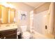 Bathroom with a single sink vanity and tile flooring, as well as a shower/tub combination with a shower curtain at 610 Sawtooth St, Westfield, IN 46074
