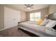 Bedroom featuring beige walls, and carpeting and a ceiling fan, and also including a large closet for storage at 610 Sawtooth St, Westfield, IN 46074