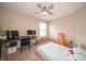 Bedroom featuring beige walls, and carpeting and a ceiling fan, currently set up as a combination playroom and office space at 610 Sawtooth St, Westfield, IN 46074