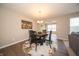 Cozy dining area with a round table, rug, and stylish decor, adjacent to the living room at 610 Sawtooth St, Westfield, IN 46074