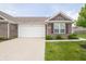 Charming brick home with a two-car garage, manicured lawn, and well-maintained landscaping at 610 Sawtooth St, Westfield, IN 46074