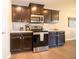 Stylish kitchen featuring dark cabinetry, stainless steel appliances, and durable granite countertops at 610 Sawtooth St, Westfield, IN 46074