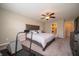 Bedroom featuring neutral walls and carpeting and a wooden bedframe with a large window for ample natural lighting at 610 Sawtooth St, Westfield, IN 46074