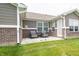 Outdoor patio features brick accents, two chairs, small side table, and an area rug at 610 Sawtooth St, Westfield, IN 46074