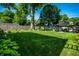 Spacious backyard with mature trees, lush lawn, and privacy fence for outdoor enjoyment at 6146 Burlington Ave, Indianapolis, IN 46220