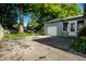 Exterior shot of a garage featuring a large tree at 6146 Burlington Ave, Indianapolis, IN 46220