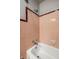 Bathroom with a tub featuring vintage tile surround and chrome fixtures at 6146 Burlington Ave, Indianapolis, IN 46220