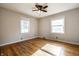 Bright bedroom with hardwood floors, two windows, ceiling fan and neutral paint at 6146 Burlington Ave, Indianapolis, IN 46220