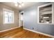 Dining room with bright windows, hardwood floors, built-in shelving, and stylish chandelier at 6146 Burlington Ave, Indianapolis, IN 46220
